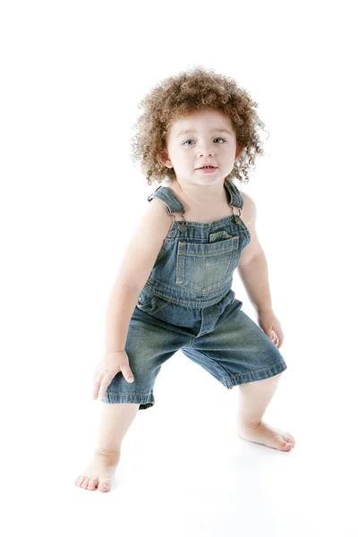 Chica de raza mixta niño usando overoles está bailando —  Fotos de Stock