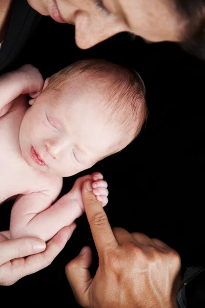 Newborn baby grasping finger — Stock Photo, Image