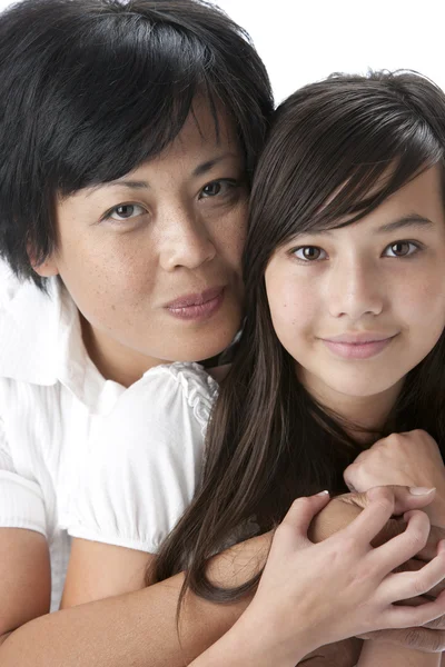 Smiling asian mother with her teenage daughter — Stock Photo, Image