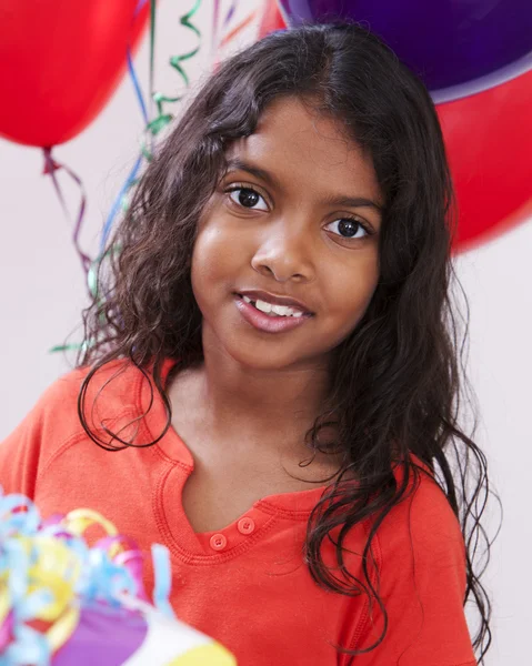 Indian little girl celebrating at a birthday party