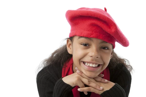 Smiling african american preteen girl wearing red hat and scarf — Stockfoto