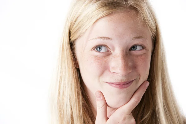 Preteen ragazza strofinando il mento Foto Stock