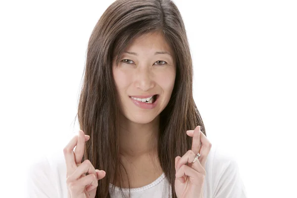 Aziatische vrouw met gekruiste vingers Stockfoto