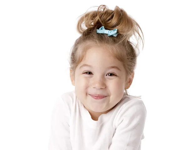 Schattig klein meisje giechelen met anticipatie Stockfoto