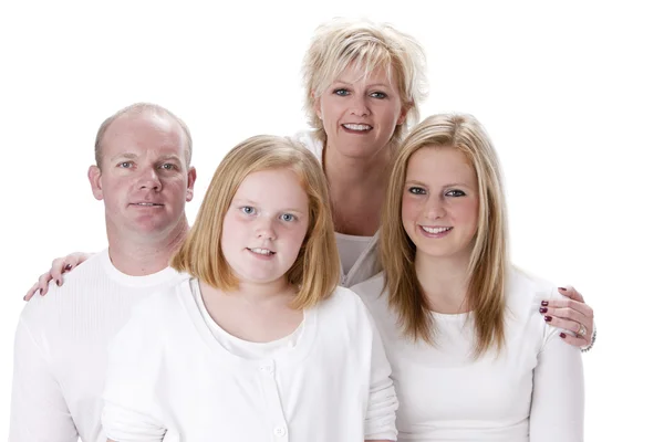 Famiglia caucasica sorridente con madre, padre e due sorelle Immagine Stock