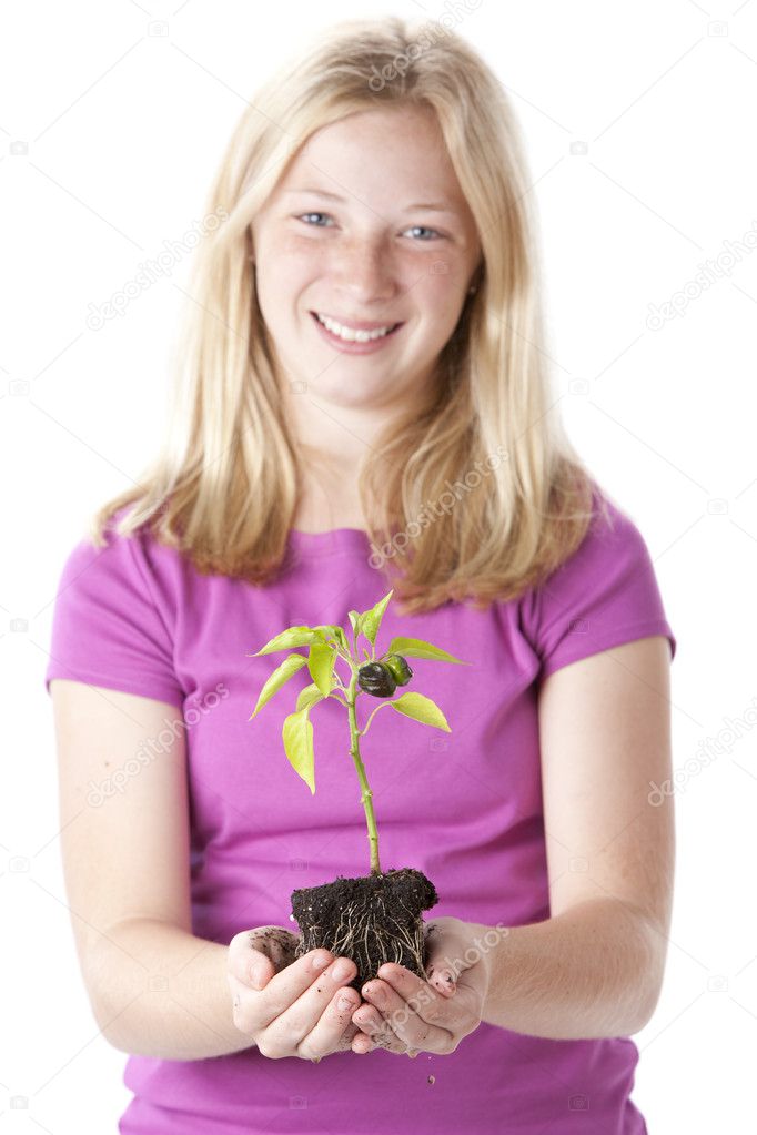 Teen girl holding green vegetable plant