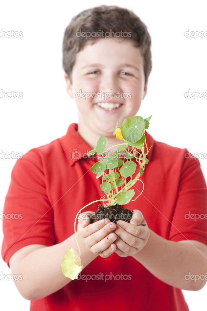 Teen boy holding green plant of nasturtium