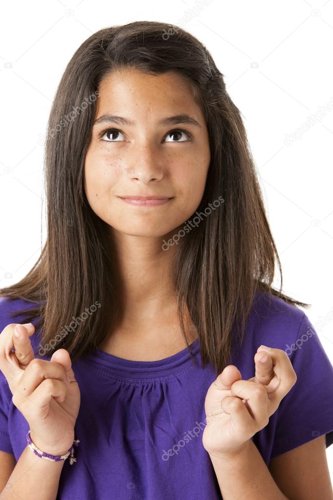 Hispanic teen teen girl crosses her fingers