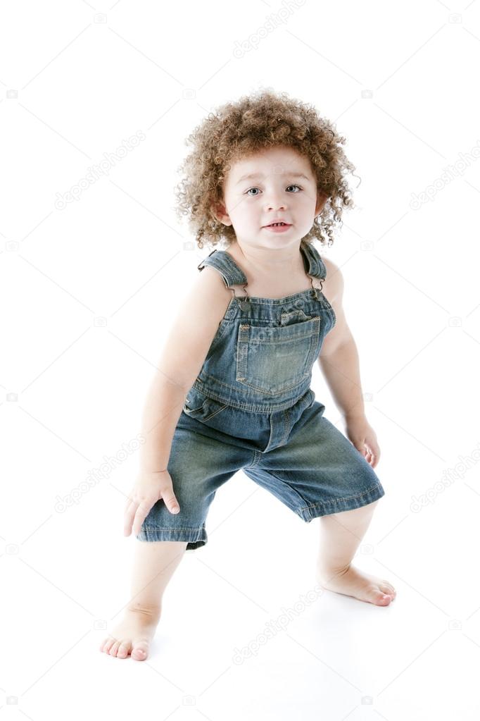 Mixed race toddler girl wearing overalls is dancing — Stock Photo