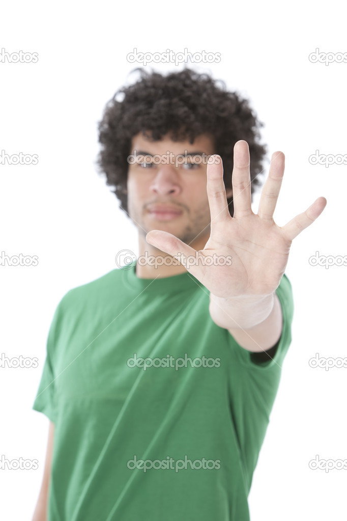Mixed race young man holding his hand up as a warning to say stop