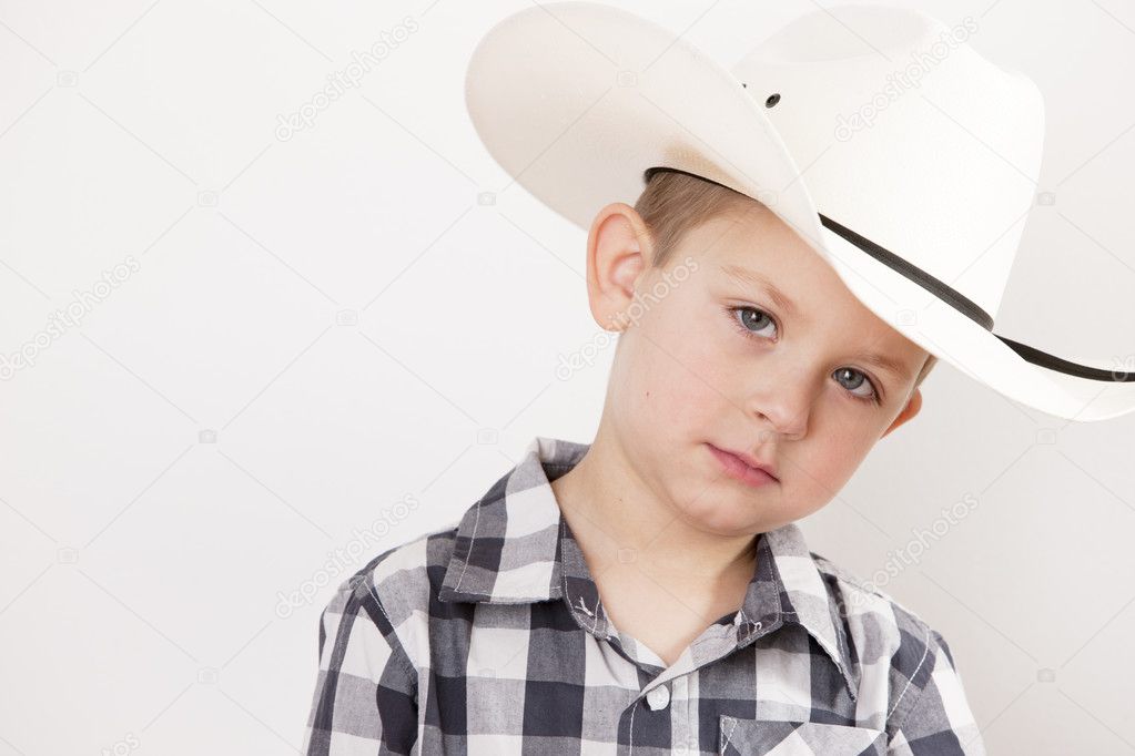 Serious little boy wearing a cowboy hat