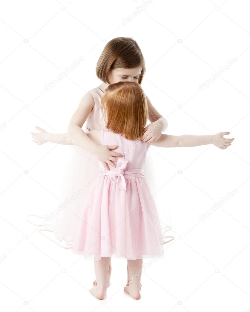 Full length image of two sisters in feminine pink dresses