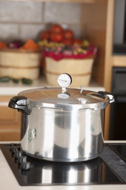 Canning. Pressure cooker used for canning homegrown fruits clipart