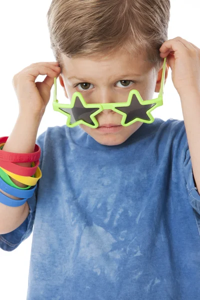 De verdad. infeliz caucásico pequeño niño mirando por encima de su estrella en forma de gafas de sol —  Fotos de Stock