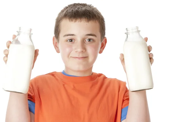Υγιεινή διατροφή. καυκάσιος εφήβου που κρατά ψηλά δύο μπουκάλια γάλα πλήρες — Φωτογραφία Αρχείου