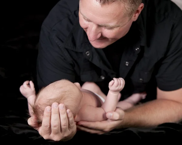 Real. Caucasian father holding his one month old newborn baby boy son — Stock Photo, Image