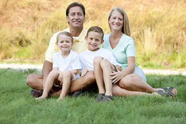 Real. Caucasian family outdoors with the mother, father, and two sons — Stock Photo, Image