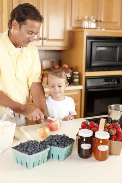 Canning. Father and son canning homegrown fruits for preserves — Stock Photo, Image