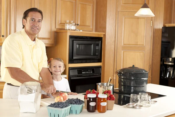 Canning. Father and son canning homegrown fruits for preserves — Stock Photo, Image