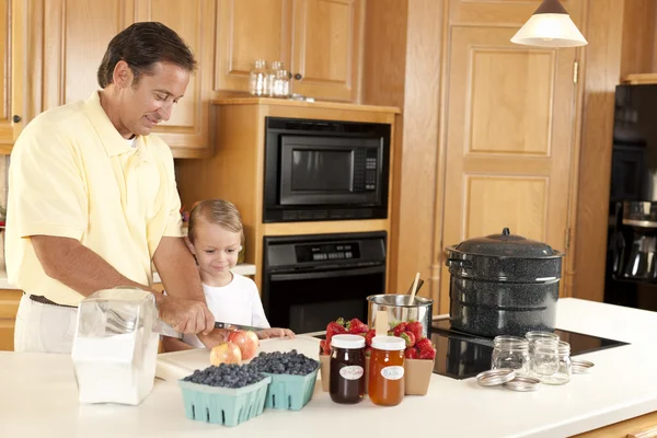 Canning. Father and son canning homegrown fruits for preserves — Stock Photo, Image