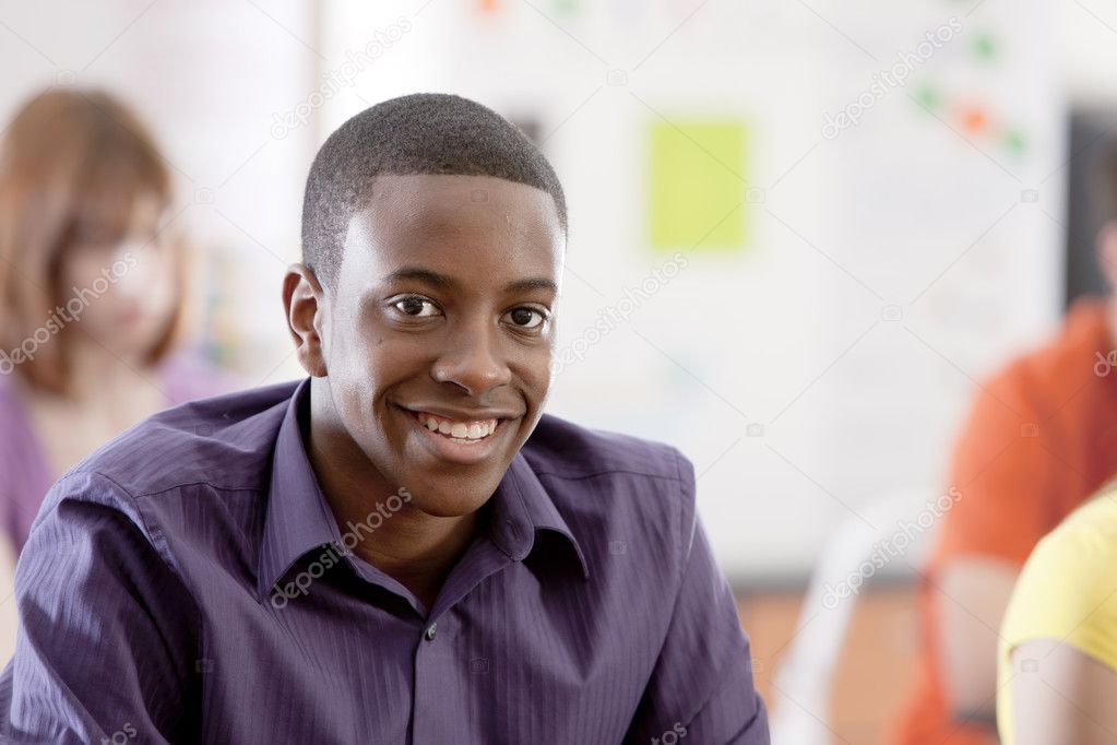 School Education. Smiling teenage boy in his high school classroom