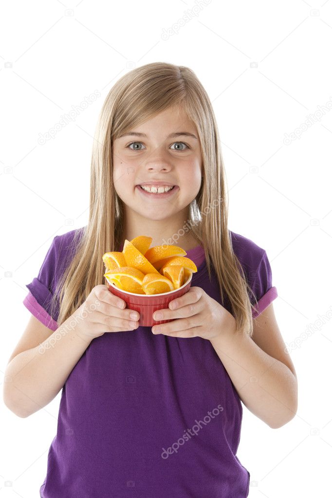 Healthy Eating. Caucasian little girl holding bowl of freshly sliced oranges