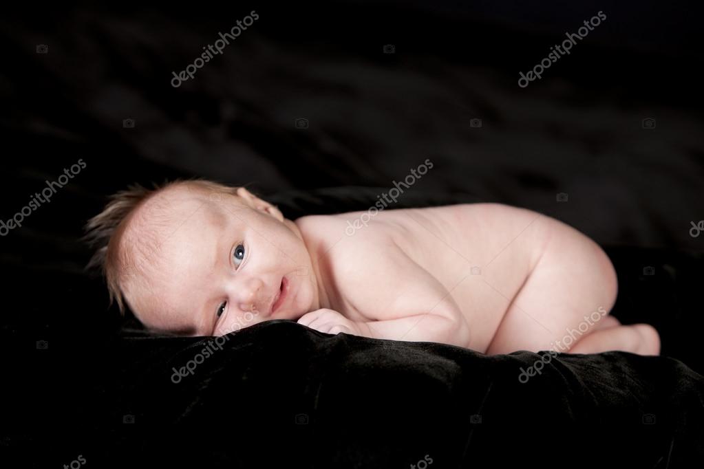 Smiling smiling one month old caucasian newborn baby boy — Stock