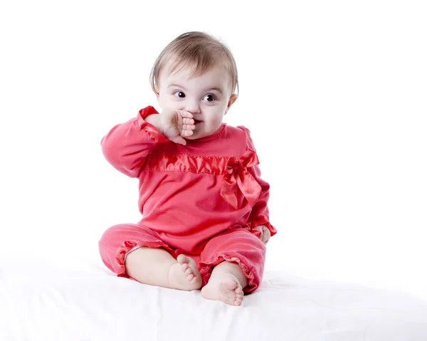 Caucasian baby girl with her hand to her mouth — Stock Photo, Image