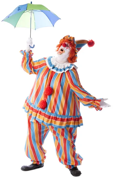 Clowns. Adult male clown holding up a colorful umbrella — Stock Photo, Image