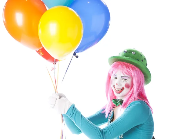 Clowns. Young teenage female clown holding a bunch of colorful helium balloons — Stock Photo, Image