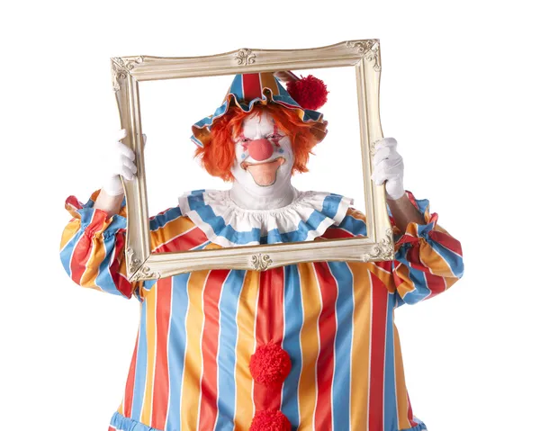 Clowns. erwachsener männlicher Clown hält einen Bilderrahmen um sein Gesicht — Stockfoto
