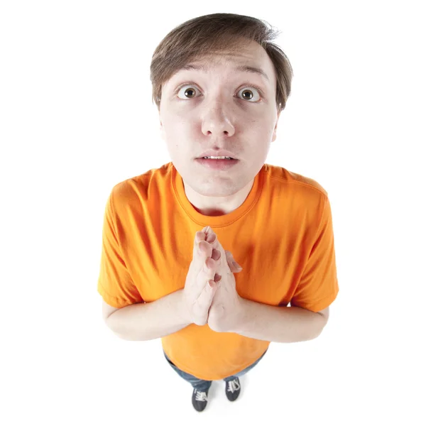 Humorous fisheye caricature teenage boy praying, wishing or hoping — Stock Photo, Image
