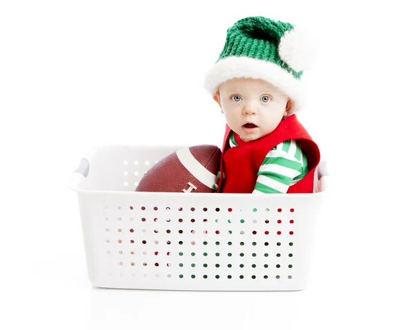 A baby boy rides in a pretend sleigh with toys — Stock Photo, Image