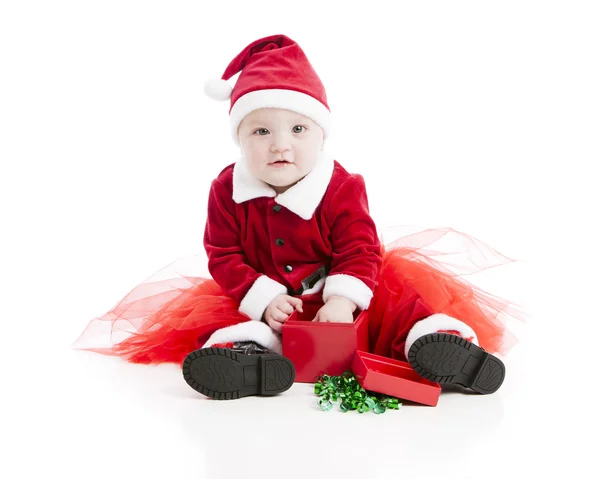 Caucasian baby girl opens a Christmas present — Stock Photo, Image