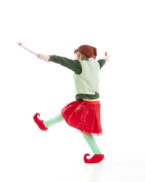 A happy, joyful, girl dances a gleeful jig with a candy — Stock Photo, Image