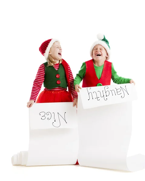 Two young elves hold Santas list of the naughty and nice girls and boys — Stock Photo, Image