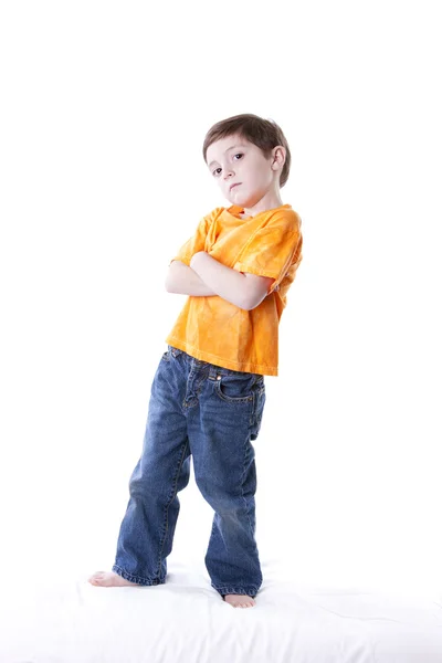 Caucasian little boy standing with his arms crossed Stock Image