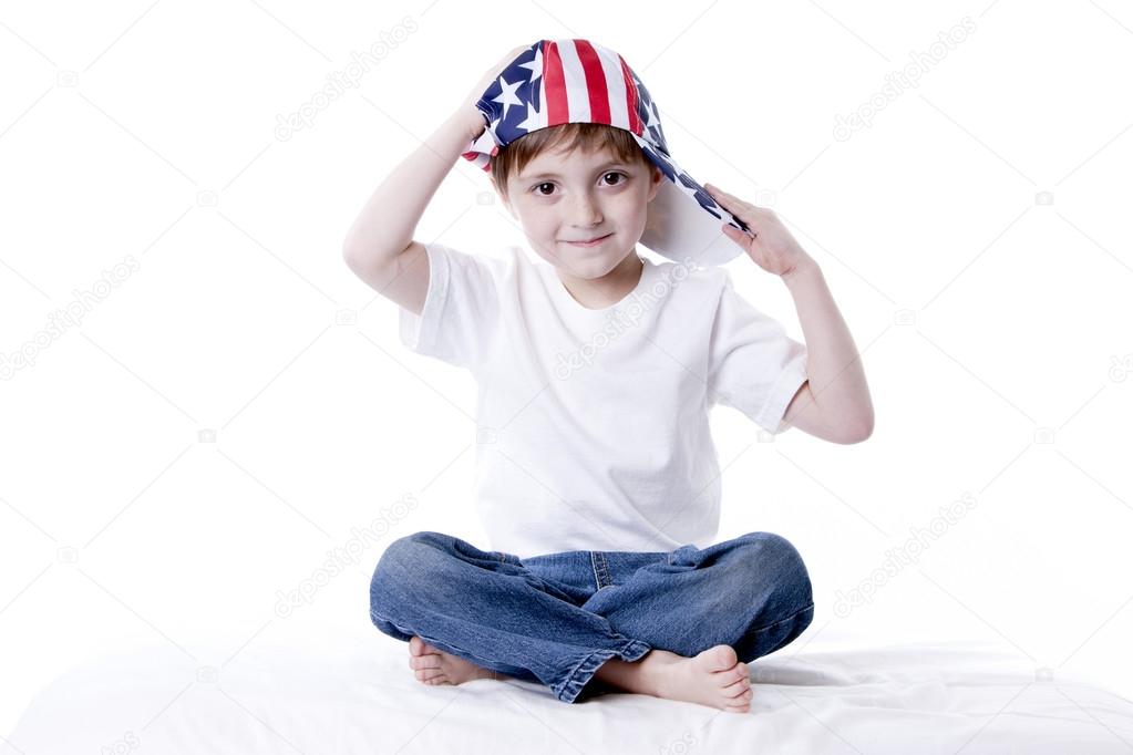 Smiling little boy wearing a patriotic American baseball cap