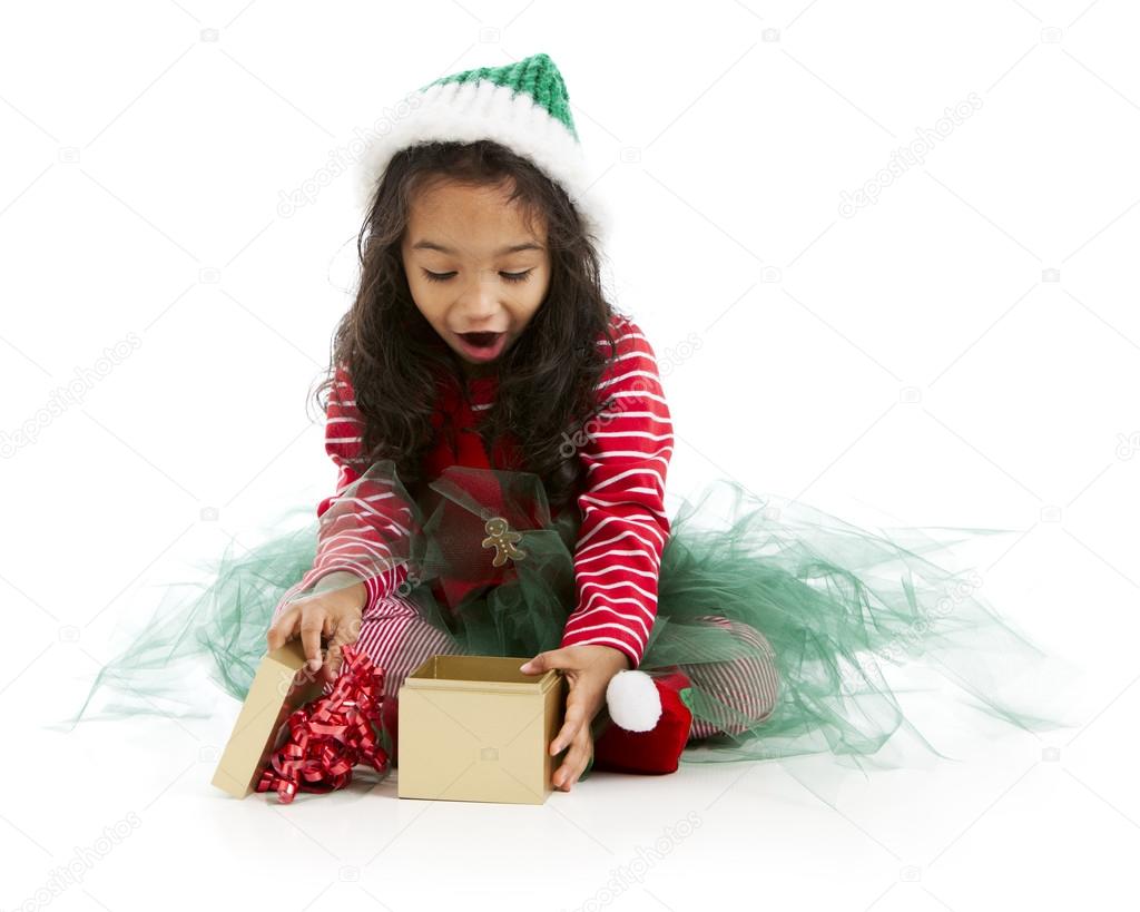Mixed race holiday elf opens a christmas present