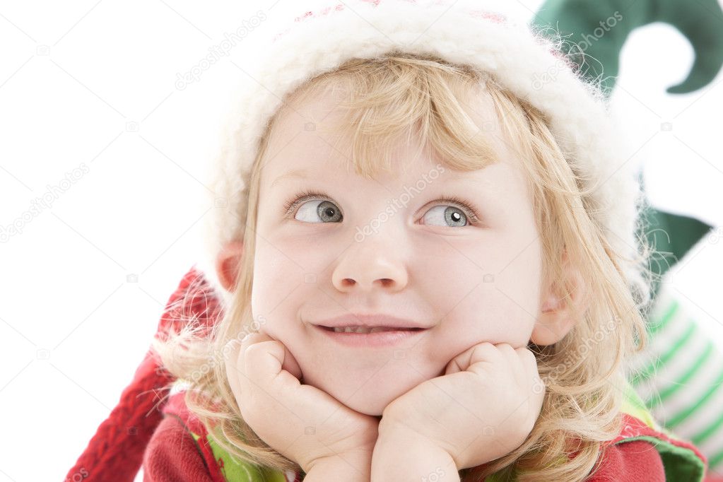 A cute little girl dressed as a christmas elf