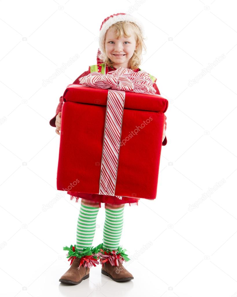 Young christmas elf holds a great big present