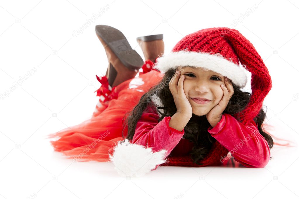 Mixed race little girl dressed like santa daydreams about christ