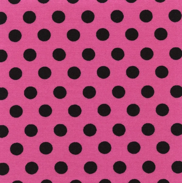 Розовая ткань высокого разрешения с черными точками польки — стоковое фото