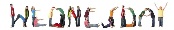 Multicultural teenagers work together to form letters of the alphabet with their bodies — Stock Photo, Image