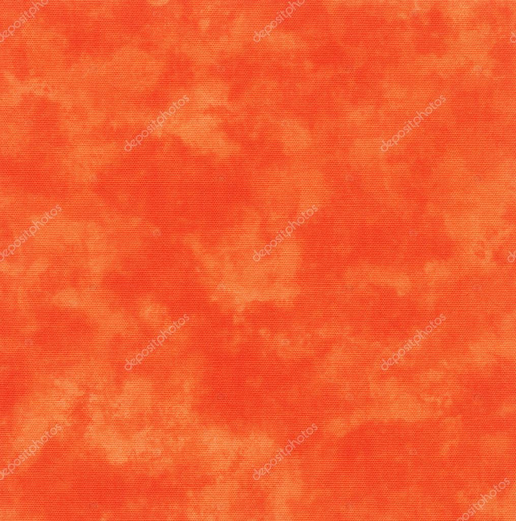 A high resolution bright orange fabric that looks like tie dye or