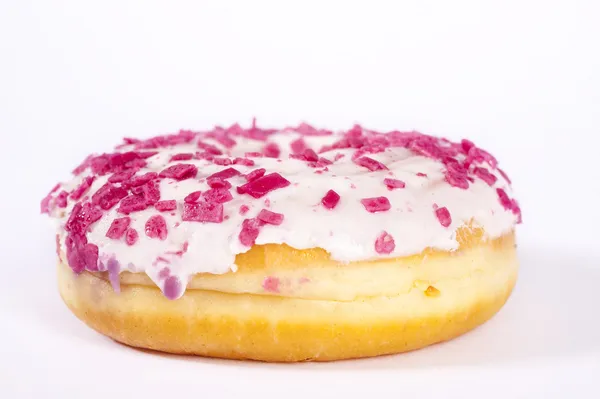 Donut with white glazing and pink sprinkles — Stock Photo, Image