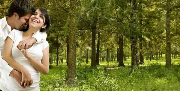 Young married happy pregnant coupe in a forest — Stock Photo, Image