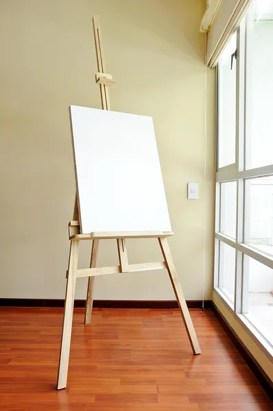 Blank canvas on a wooden tripod in the studio — Stock Photo, Image