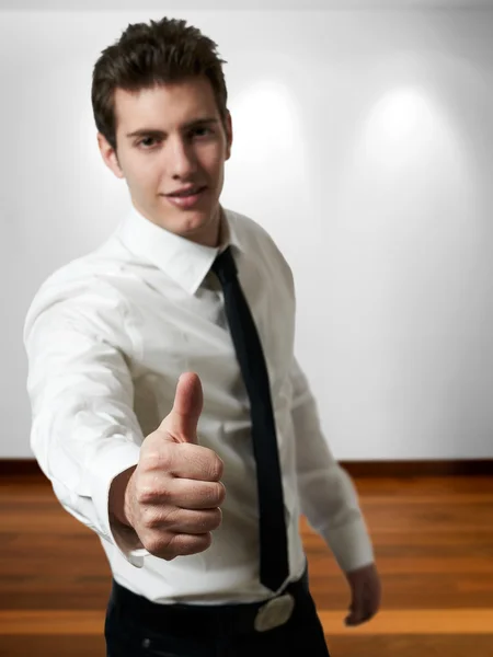 Young successful business man with thumb up at office — Stock Photo, Image