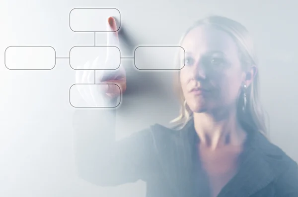 Business woman touching digital screen displaying a diagram — Stock Photo, Image